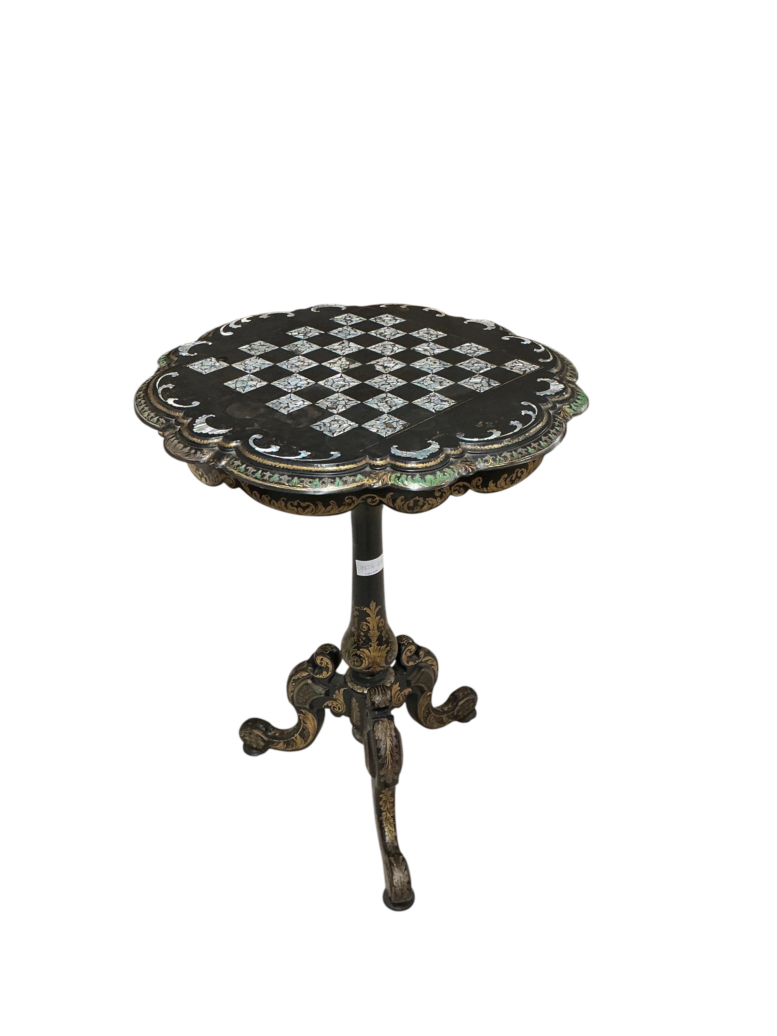 A Victorian mother of pearl inlaid papier mache circular tilt top tripod games table, diameter 56cm, height 74cm